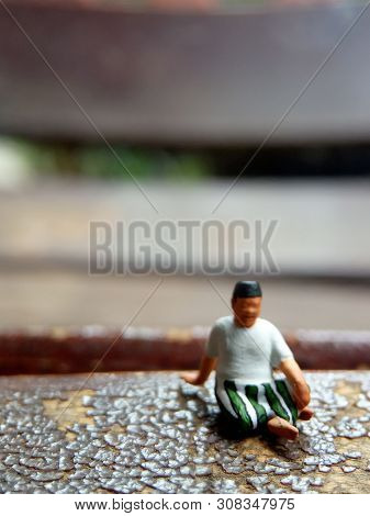Mini Figure Toy Old Man Sit At Scratch Wooden Chair, With Copy Or Negative Space For Text Placement 