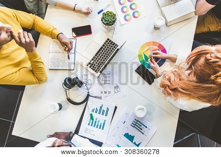 Top Wiev Table. Group Of Multi Ethnic Executives Discussing During A Meeting. Business Man And Woman