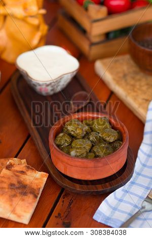 Yarpag Dolmasi, Yaprak Sarmasi, Green Grape Leaves Stuffed With Rice And Meat In Pottery Bowl With Y