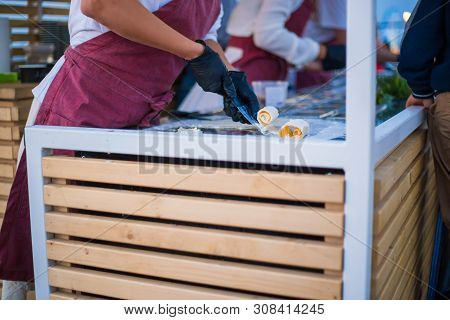 Chef Cooking Asian Natural Stir-fried Ice Cream Rolls At Freeze Pan. Outdoor Cooking, Gastronomy And