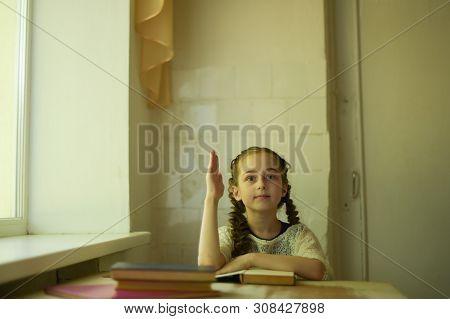 Pupil In School Uniform With Braids. Girl Schoolgirl At School With Book In School Uniform. Training