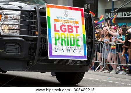 2018 JUNE 24 NEW YORK: NY City Council parade vehicle with LGBT Pride March on a large rainbow colored poster hung from the front grill along 5th Ave.