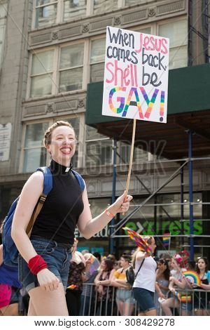 2018 JUNE 24 NEW YORK: NYC Pride March participant holds a sign that says When Jesus Comes Back She ll Be Gay on the 5th Ave parade route.