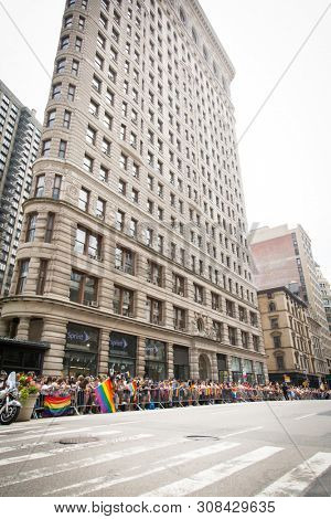 2018 JUNE 24 NEW YORK: NYC Pride March spectators wave rainbow flags and cheer the participants at 23rd St and 5th Ave.