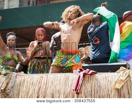 2018 JUNE 24 NEW YORK: NYC Pride March participant dances while riding on a parade float along the 5th Ave route.