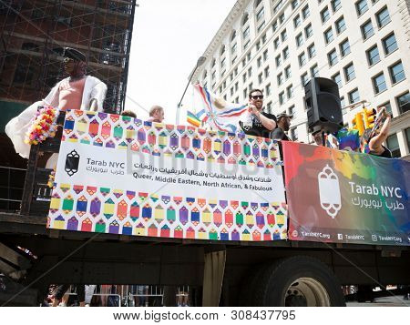 2018 JUNE 24 NEW YORK: NYC Pride March participants ride on the Tarab NYC float, a non-profit inclusive organization for Arab, Middle Eastern, and North African people, MENA, on 5th Ave.