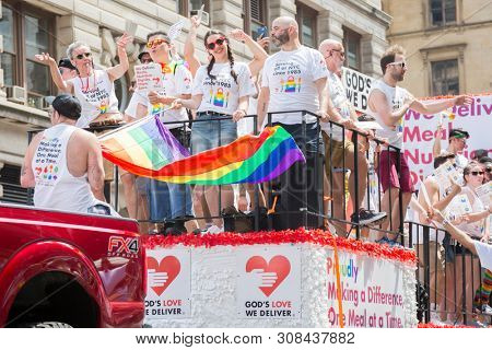 2018 JUNE 24 NEW YORK: NYC Pride March participants ride on the Gods Love We Deliver float on the 5th Ave parade route.