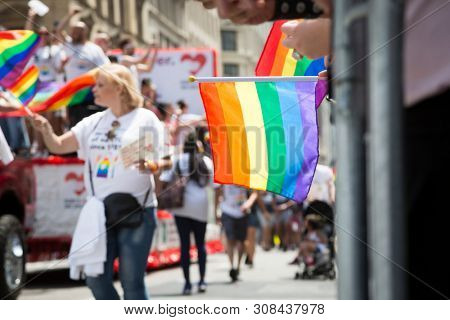 2018 JUNE 24 NEW YORK: NYC Pride March spectators wave rainbow flags and cheer the participants at 23rd St and 5th Ave.