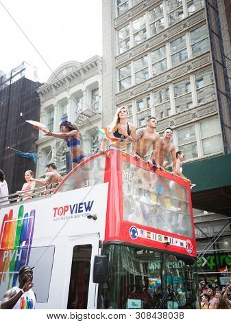 2018 JUNE 24 NEW YORK: NYC Pride March participants wearing only company brand underwear ride on the PVH parade float on 5th Ave route. Phillips-Van Heusen Corporation is an American clothing company.