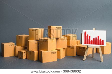 A Big Pile Of Cardboard Boxes And A Stand With Information Chart. Increasing Consumer Demand, Export