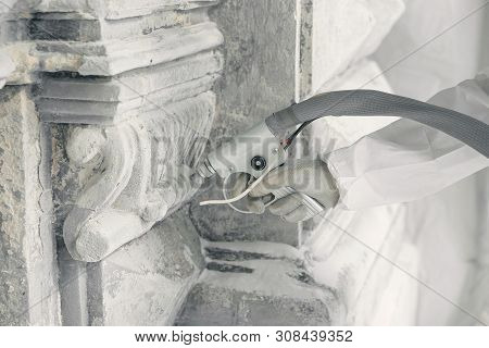 Hand Of Worker With The Gun For Serving A High-pressure Sand Jet. Restoration Of Historical Buildind