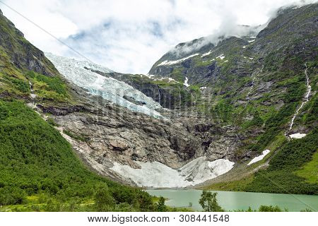 Landscape With River Near Briksdal Or Briksdalsbreen Glacier In Olden, Norway With Green Mountain. N