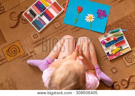 A Little Girl Plays And Sculpts From Clay. Modeling Of Plasticine And The Development Of Fine Motor