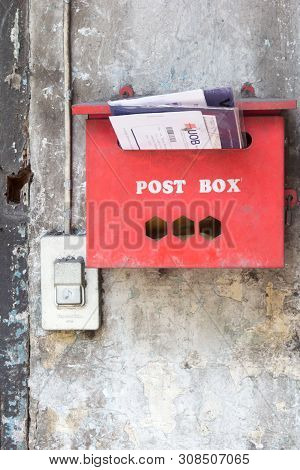 Bangkok, Thailand - April 25th 2016: Red Postbox With Letters Hanging On A Wall. Red Is A Common Col