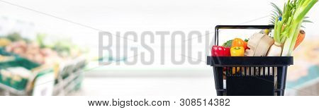 Black Shopping Basket Full Of Food And Groceries In Suppermarket Banner Background With Copy Space