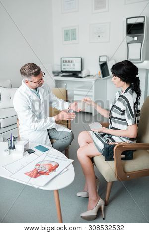 Plastic Surgeon Consulting Woman About Different Implants