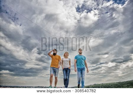 United Group Purposefully Moves Forward. Men And Woman Walks Dramatic Cloudy Sky Background. True Fr