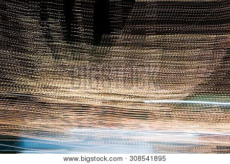 Abstract Of Multicolored Lights Stripes Moving Fast In Dark Background. Orange Violet And Bluel Back