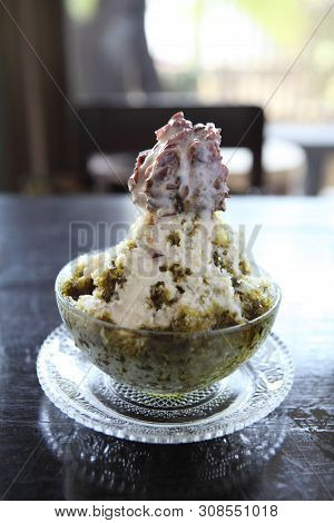 Traditional Japanese Dessert , A Bowl Of Red Bean Sweet With Red Ice On Wood Pattern
