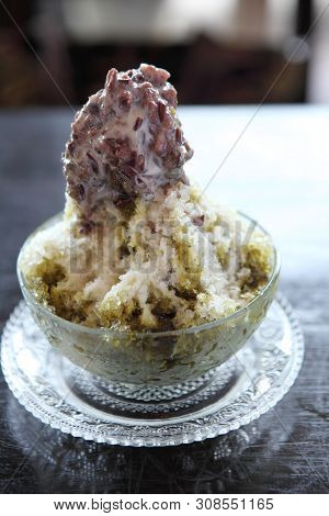 Traditional Japanese Dessert , A Bowl Of Red Bean Sweet With Red Ice On Wood Pattern