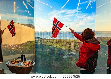 Tourist Woman With Norwegian Flag Enjoying Sea Coast View From Inside Of Mirrored Toilet Bukkekjerka