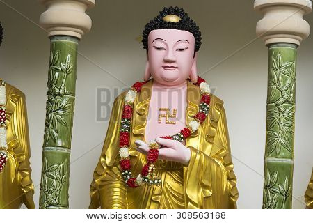 Standing Buddha Figure With A Left Facing Swastika On His Chest At The Buddhist Kek Lok Si Temple, A