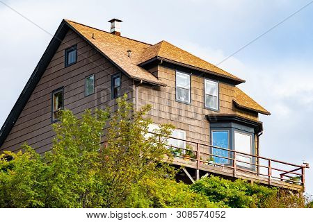 Traditional Charming Brown Cabin Lodge Duplex Home With Gable Roof, Glass Windows And Chimney Above 