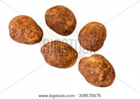 Potatoes isolated on white, top view.  Unwashed organic sebago variety.