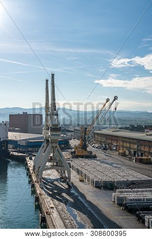 Koper, Slovenia - 24 May 2019: Cranes Line The Quayside In The Port Of Koper In Slovenia