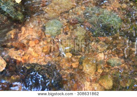 The Clear Water Flows Through The Gravel Are Smooth And Very Cool. Originated From Natural Waterfall