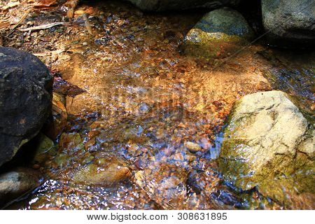 The Clear Water Flows Through The Gravel Are Smooth And Very Cool. Originated From Natural Waterfall