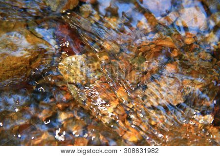 The Clear Water Flows Through The Gravel Are Smooth And Very Cool. Originated From Natural Waterfall