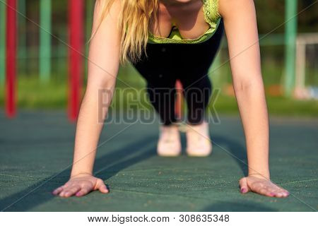 Stretching Woman Training Trains In Workout Sports Ground. Doing Exercise Plank
