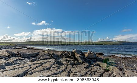 Spectacular Bare Limestone Landscape And Ocean In Doolin Bay With The Cliffs Of Moher In The Backgro