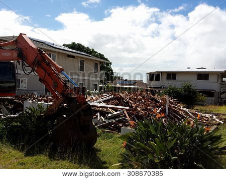 Honolulu - June 21, 2013: Construction Hitachi Bulldozer Tears Down Home Of Lot In Kapahulu On Oahu,