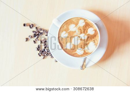 Top View Of Hot Cappuccino Coffee With Nice Pattern Foam On Table