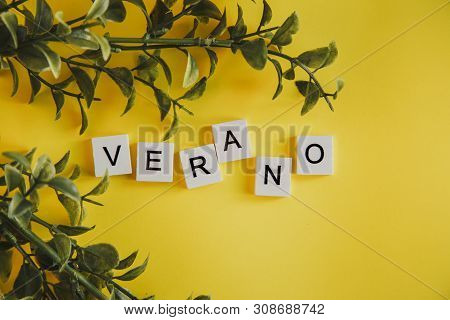 The Inscription Verano In Spanish On The Letters Of The Keyboard On A Yellow Background With Branche