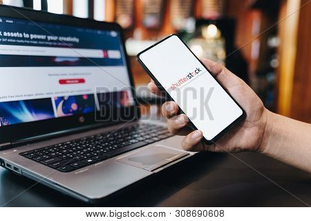Chiang Mai, Thailand - May.11,2019: Woman Holding Apple Iphone 6s Rose Gold With Shutterstock On Scr