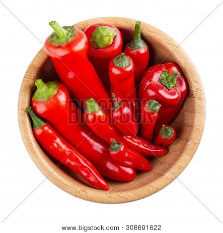 Red Pepper In Wooden Bowl Isolated On White Background. Top View,  Close-up. Ramiro And Chili Pepper