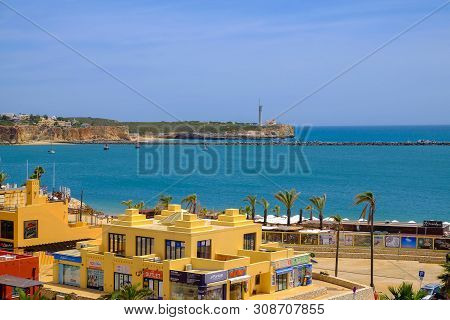 Portimao, Portugal - Mai 24, 2019: View On The Lighthouse, The Residential Part Of The City With Col