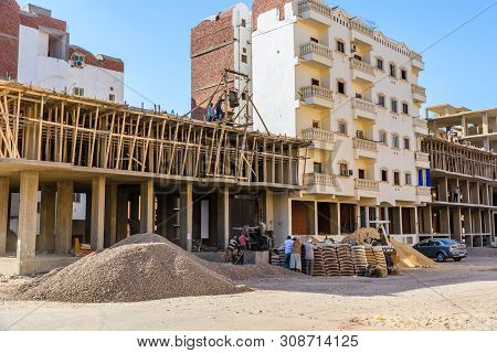 Hurghada, Egypt - December 6, 2018: Construction Of New Modern Residential Building, Workers Pour Co