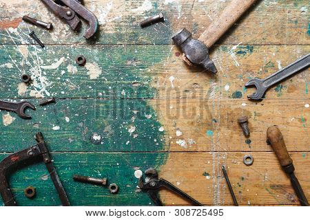 Flat Lay Set Of Vintage Carpentry Tools On Colorful Wooden Background. Top View Workbench With Carpe
