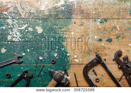 Flat Lay Set Of Vintage Carpentry Tools On Colorful Wooden Background. Top View Workbench With Carpe