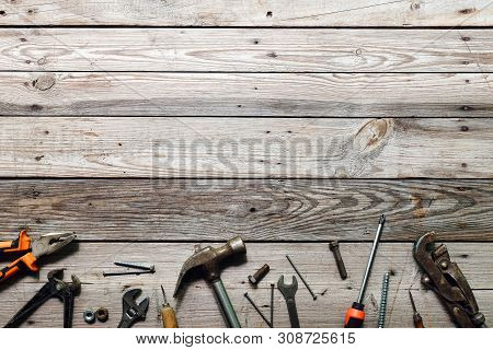 Flat Lay Composition With Vintage Carpentry Tools On Rough Wooden Background. Top View Workbench Wit