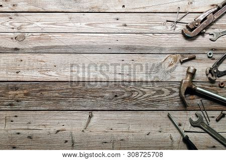Flat Lay Composition With Vintage Carpentry Tools On Rough Wooden Background. Top View Workbench Wit