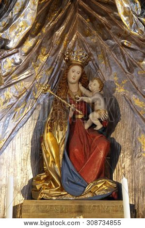 WURZBURG, GERMANY - JULY O4, 2018: Madonna with child Jesus, altar in the Neumunster Collegiate Church in Wurzburg, Germany
