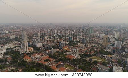 Aerial Cityscape Modern City Surabaya With Skyscrapers, Buildings And Houses. Sunset In City Skyline