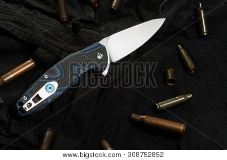 Photo Of The Back Side Of The Knife. Clip On The Back Of The Knife. Knife On Black Fabric.