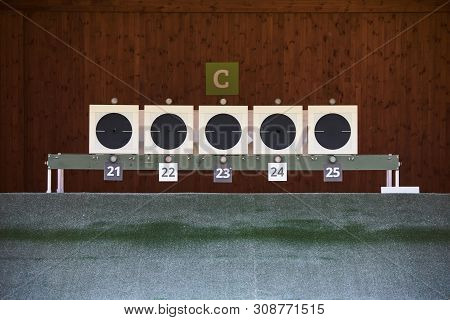 Bullseye Target With Bullet Holes In Center, Close-up. Gun Shooting Range