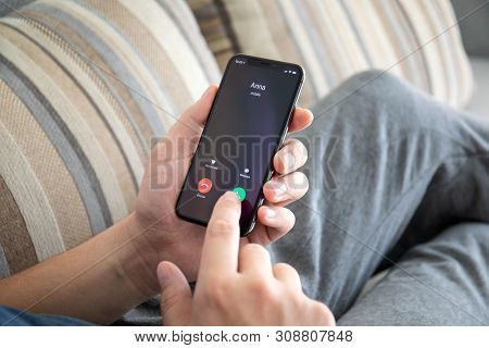 Alushta, Russia - October 9, 2018: Man Hand Holding Iphone X With Call Number On The Screen. Iphone 